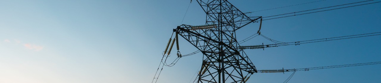 Power line in front of a blue sky.