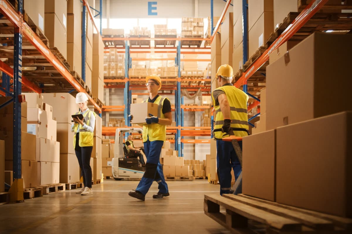 Workers moving boxes in a warehouse.